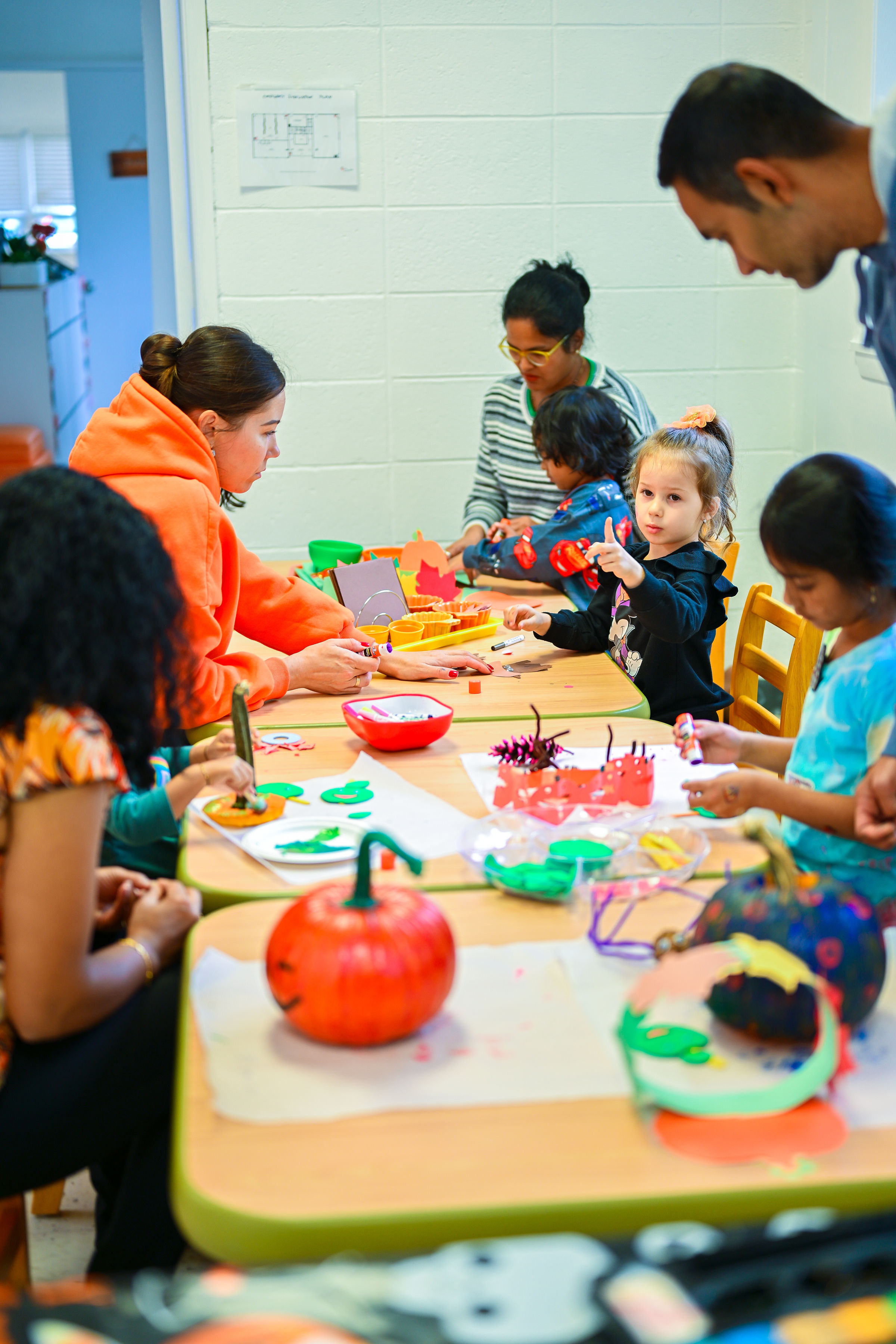 Children painting pumpkins at summer camp